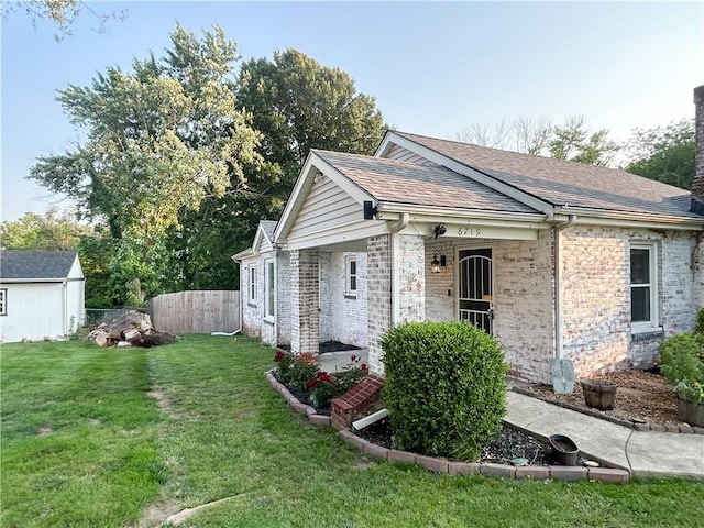 8719 E 57th St, Raytown, MO 64129 - ranch-style home featuring brick siding, roof with shingles, a chimney, and an outbuilding