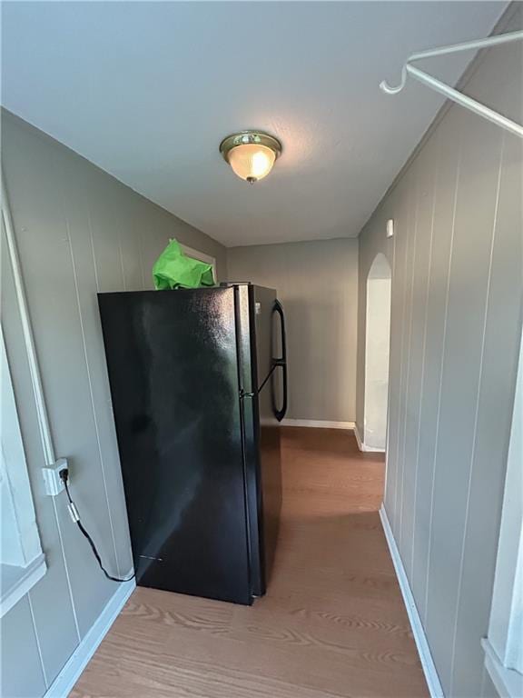 8719 E 57th St, Raytown, MO 64129 - kitchen with freestanding refrigerator, light wood-type flooring, and arched walkways