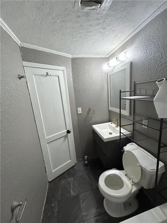 8719 E 57th St, Raytown, MO 64129 - half bath featuring a textured wall, vanity, a textured ceiling, and crown molding