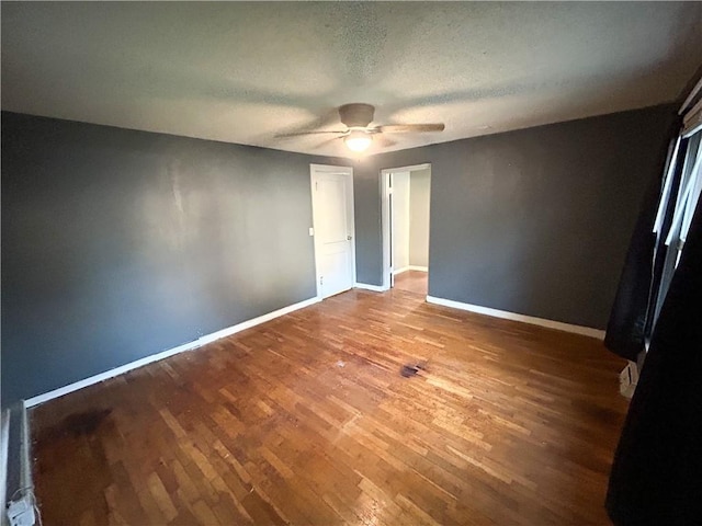 8719 E 57th St, Raytown, MO 64129 - empty room featuring a ceiling fan, wood finished floors, and a textured ceiling