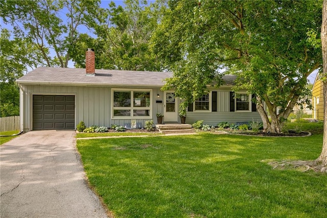 7135 Conser St, Overland Park, KS 66204 - ranch-style home with a garage, a chimney, asphalt driveway, and board and batten siding