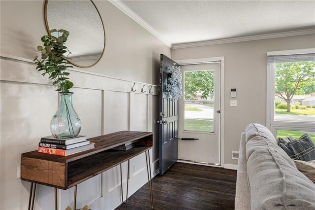 7135 Conser St, Overland Park, KS 66204 - entrance foyer featuring a textured ceiling, dark wood-style floors, ornamental molding, and healthy amount of natural light
