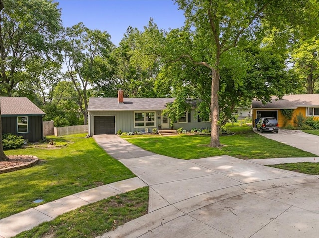 7135 Conser St, Overland Park, KS 66204 - view of front of home featuring an attached garage, a chimney, driveway, and board and batten siding