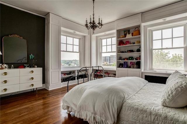 4618 Warwick Blvd Unit 7F, Kansas City, MO 64112 - bedroom featuring a chandelier and dark wood-style flooring