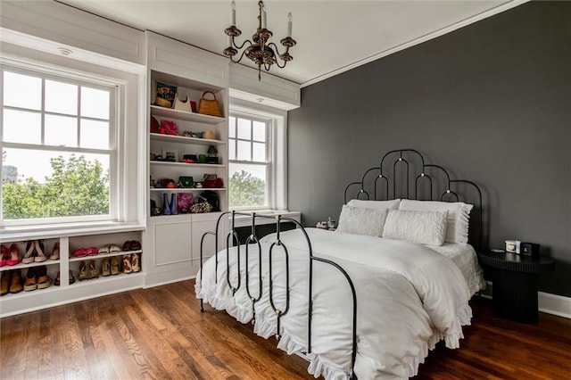 4618 Warwick Blvd Unit 7F, Kansas City, MO 64112 - bedroom featuring a chandelier, wood finished floors, and ornamental molding