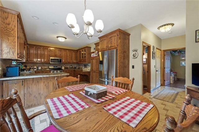 3917 SW Windjammer Ct, Lees Summit, MO 64082 - dining room featuring a chandelier and stone tile flooring