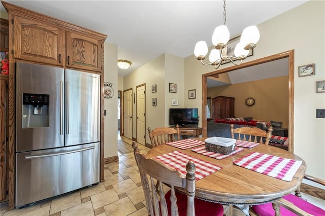 3917 SW Windjammer Ct, Lees Summit, MO 64082 - dining space featuring a chandelier, stone finish flooring, and baseboards