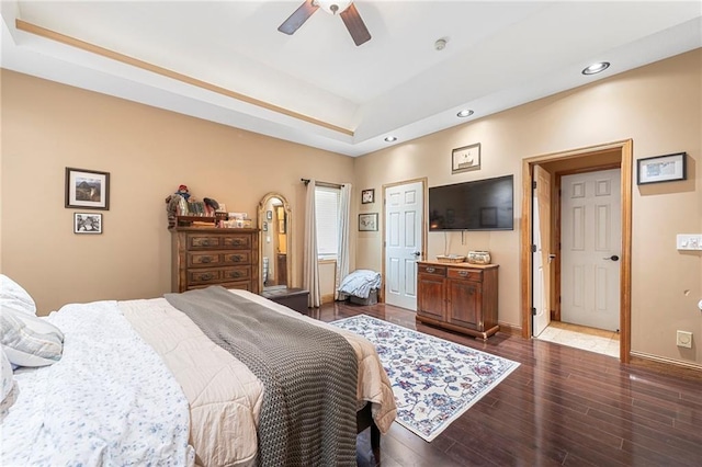 3917 SW Windjammer Ct, Lees Summit, MO 64082 - bedroom featuring a tray ceiling, recessed lighting, dark wood-style flooring, ceiling fan, and baseboards