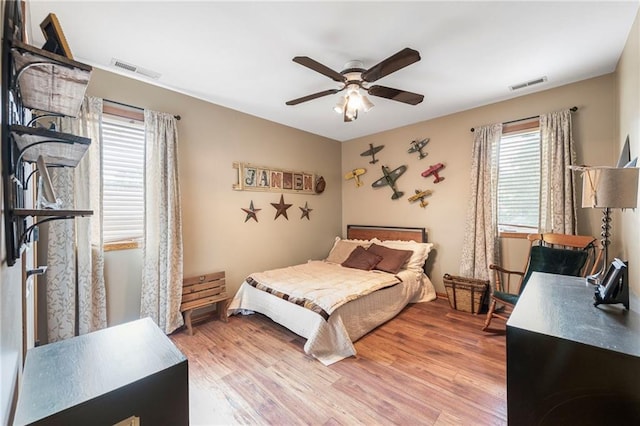 3917 SW Windjammer Ct, Lees Summit, MO 64082 - bedroom featuring multiple windows, light wood finished floors, and a ceiling fan