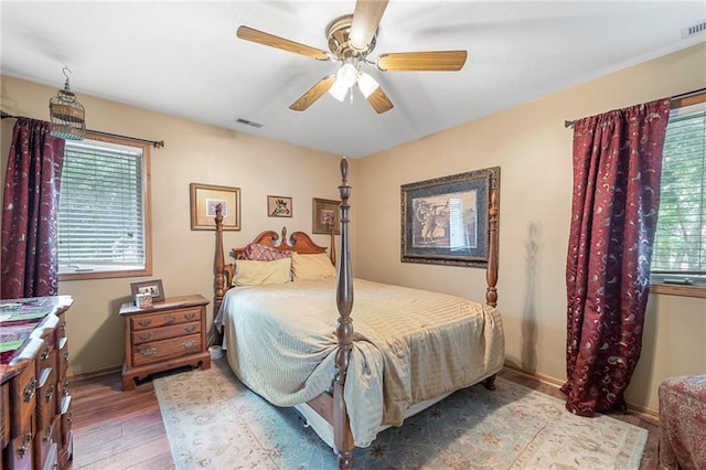3917 SW Windjammer Ct, Lees Summit, MO 64082 - bedroom with wood finished floors, multiple windows, and ceiling fan