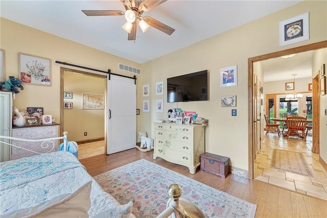 3917 SW Windjammer Ct, Lees Summit, MO 64082 - bedroom with a barn door, wood finished floors, and baseboards