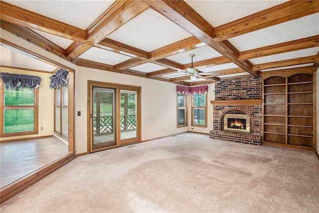 2409 NE 73rd Ter, Gladstone, MO 64118 - unfurnished living room with carpet, a ceiling fan, beam ceiling, coffered ceiling, and a fireplace