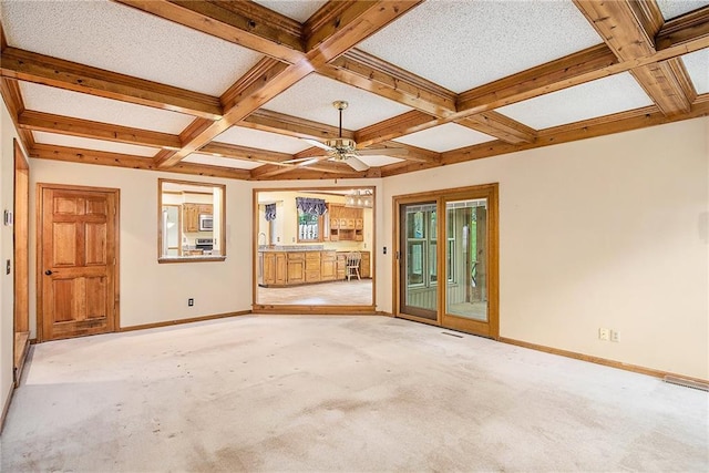 2409 NE 73rd Ter, Gladstone, MO 64118 - spare room featuring coffered ceiling, baseboards, beam ceiling, ceiling fan, and light colored carpet