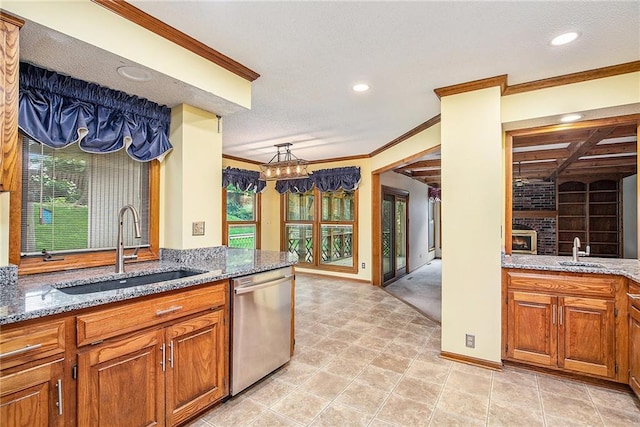 2409 NE 73rd Ter, Gladstone, MO 64118 - kitchen featuring stainless steel dishwasher, a sink, crown molding, light stone counters, and plenty of natural light