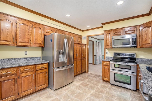 2409 NE 73rd Ter, Gladstone, MO 64118 - kitchen featuring appliances with stainless steel finishes, brown cabinets, crown molding, recessed lighting, and stone countertops