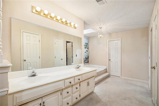 2409 NE 73rd Ter, Gladstone, MO 64118 - full bathroom with double vanity and a textured ceiling