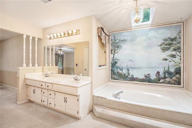 2409 NE 73rd Ter, Gladstone, MO 64118 - bathroom with double vanity, a bath, a textured ceiling, and ceiling fan