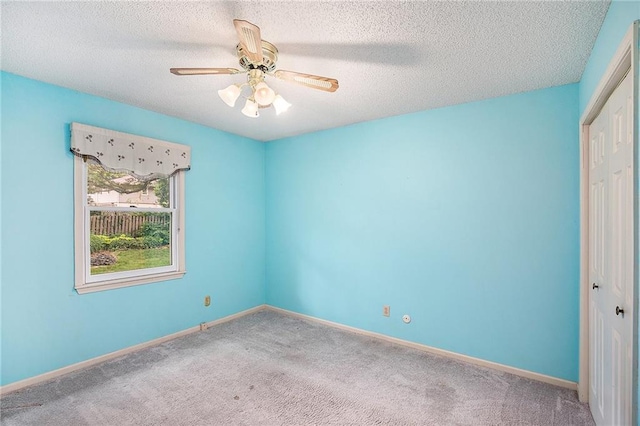 2409 NE 73rd Ter, Gladstone, MO 64118 - unfurnished bedroom featuring a closet, carpet, a ceiling fan, baseboards, and a textured ceiling