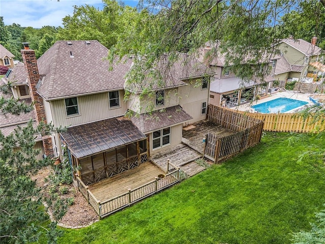 2409 NE 73rd Ter, Gladstone, MO 64118 - back of house featuring a shingled roof, a sunroom, and a chimney