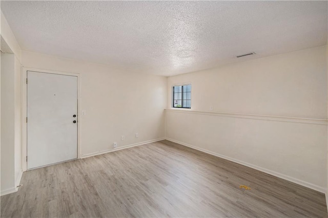 2701 NW 5th St, Blue Springs, MO 64014 - empty room featuring a textured ceiling and wood finished floors