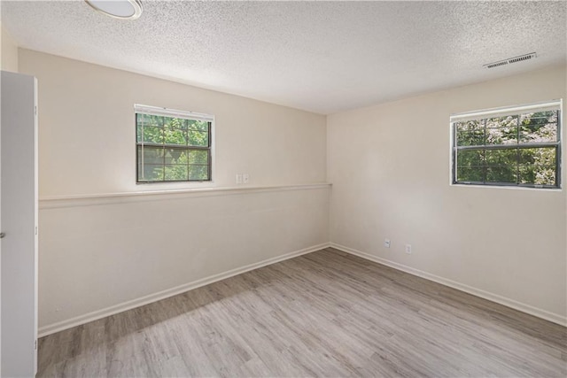 2701 NW 5th St, Blue Springs, MO 64014 - unfurnished room featuring a textured ceiling and wood finished floors