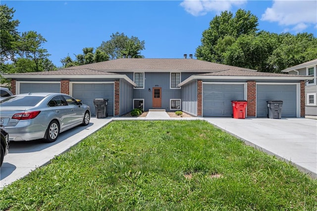 2701 NW 5th St, Blue Springs, MO 64014 - view of front of property featuring a front yard, concrete driveway, board and batten siding, and brick siding