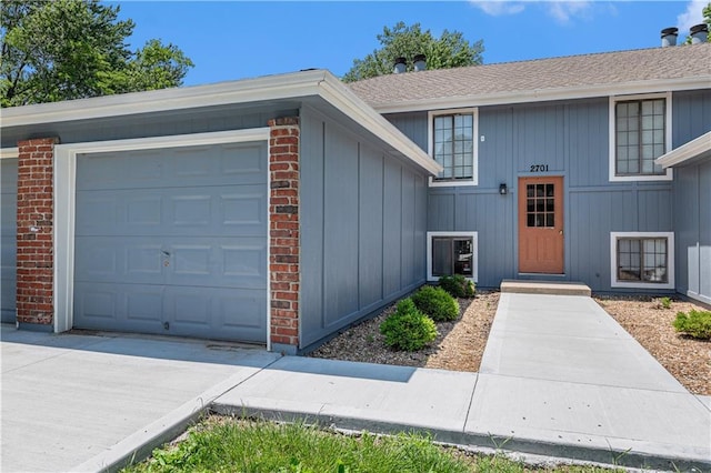 2701 NW 5th St, Blue Springs, MO 64014 - view of front of home with brick siding, a garage, and driveway