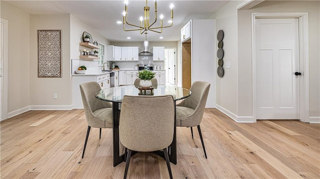 126 E Bridlespur Dr, Kansas City, MO 64114 - dining room featuring baseboards, a chandelier, light wood-style flooring, and recessed lighting