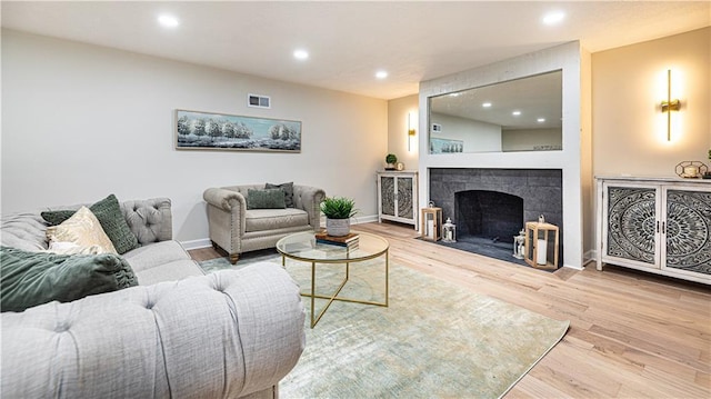 126 E Bridlespur Dr, Kansas City, MO 64114 - living room with wood finished floors, baseboards, recessed lighting, and a tile fireplace