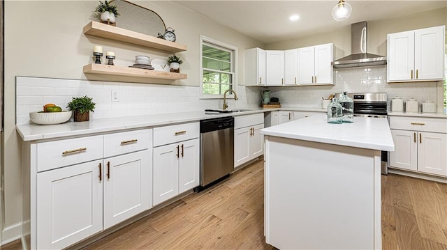 126 E Bridlespur Dr, Kansas City, MO 64114 - kitchen with wall chimney range hood, stainless steel dishwasher, backsplash, a sink, and recessed lighting