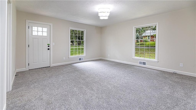 126 E Bridlespur Dr, Kansas City, MO 64114 - carpeted foyer with a textured ceiling and baseboards