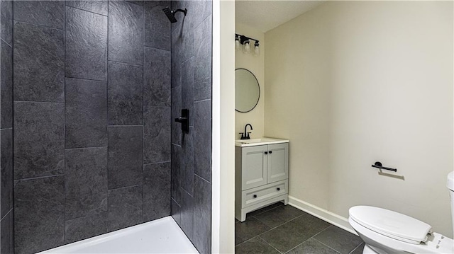 126 E Bridlespur Dr, Kansas City, MO 64114 - full bathroom with vanity, a tile shower, toilet, tile patterned flooring, and baseboards