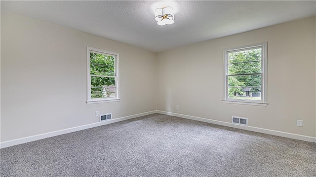 126 E Bridlespur Dr, Kansas City, MO 64114 - unfurnished room with healthy amount of natural light, baseboards, carpet flooring, and a textured ceiling