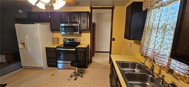 123 NW 1501st Rd, Holden, MO 64040 - kitchen featuring stainless steel appliances, light countertops, a sink, and a ceiling fan