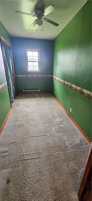 123 NW 1501st Rd, Holden, MO 64040 - empty room with carpet, a ceiling fan, and baseboards