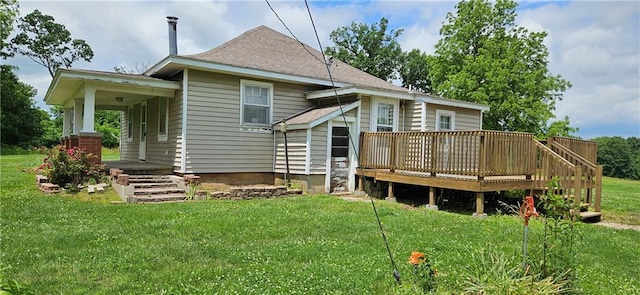 123 NW 1501st Rd, Holden, MO 64040 - rear view of property with a lawn, roof with shingles, and a deck