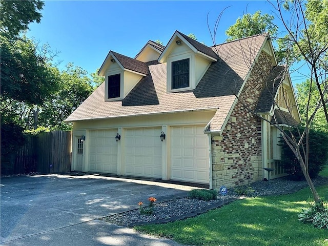 925 S Walnut St, Maryville, MO 64468 - view of home's exterior with a garage, a shingled roof, and stone siding