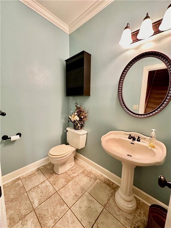 925 S Walnut St, Maryville, MO 64468 - half bath with ornamental molding, baseboards, toilet, and tile patterned flooring