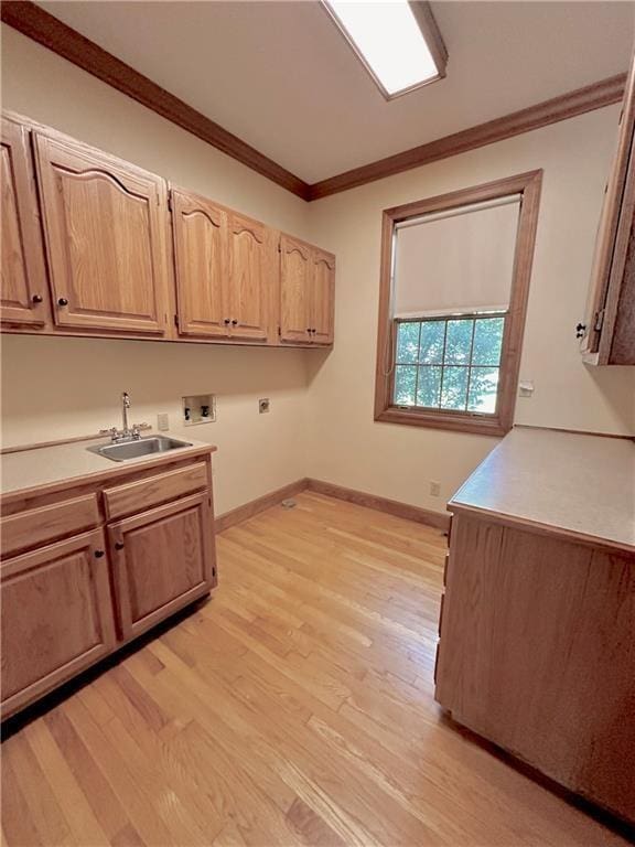 925 S Walnut St, Maryville, MO 64468 - laundry room featuring washer hookup, cabinet space, crown molding, light wood-style flooring, and electric dryer hookup