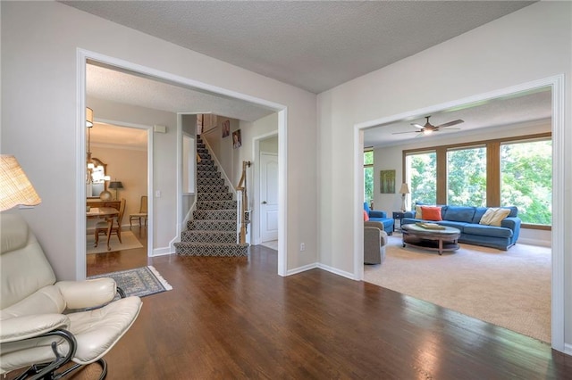 8355 Hallet St, Lenexa, KS 66215 - living area featuring stairway, wood finished floors, a textured ceiling, and a ceiling fan