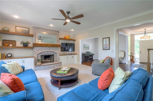 8355 Hallet St, Lenexa, KS 66215 - living room with ceiling fan, ornamental molding, a brick fireplace, recessed lighting, and a textured ceiling
