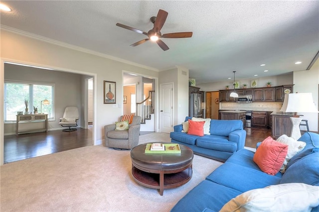 8355 Hallet St, Lenexa, KS 66215 - living area with dark colored carpet, a ceiling fan, recessed lighting, ornamental molding, and stairs