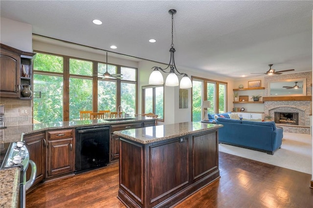 8355 Hallet St, Lenexa, KS 66215 - kitchen with dishwasher, a ceiling fan, stainless steel range oven, a kitchen island, and dark wood-style flooring