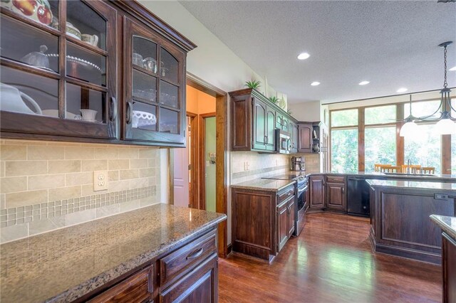 8355 Hallet St, Lenexa, KS 66215 - kitchen featuring stainless steel appliances, recessed lighting, dark wood finished floors, tasteful backsplash, and glass insert cabinets