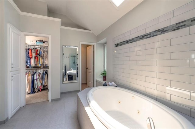 8355 Hallet St, Lenexa, KS 66215 - bathroom featuring a tub with jets, lofted ceiling, and a spacious closet
