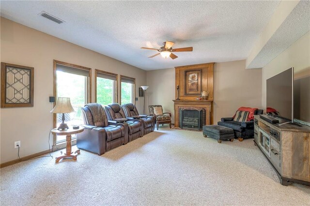 8355 Hallet St, Lenexa, KS 66215 - living area featuring light colored carpet, a ceiling fan, a textured ceiling, and a large fireplace