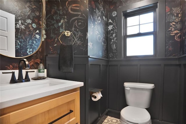 1245 NE Goshen Dr, Lees Summit, MO 64064 - bathroom with a decorative wall, vanity, wainscoting, and wallpapered walls