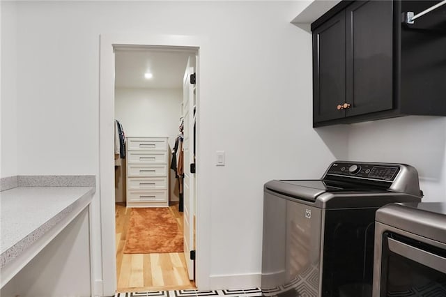 1245 NE Goshen Dr, Lees Summit, MO 64064 - laundry room featuring cabinet space, washer and clothes dryer, light wood finished floors, and recessed lighting