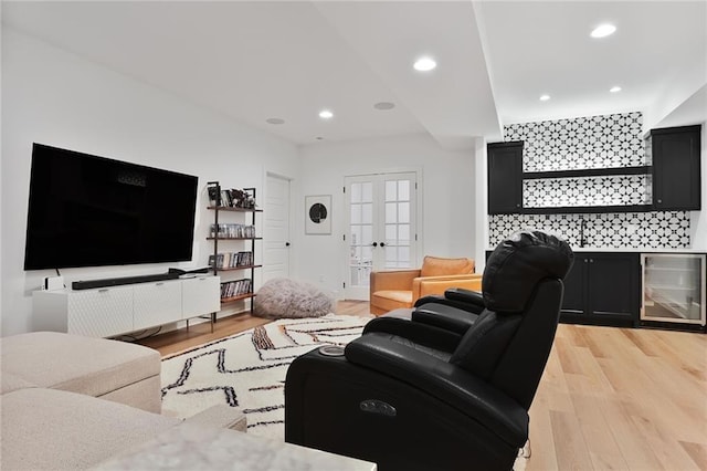 1245 NE Goshen Dr, Lees Summit, MO 64064 - living room featuring wine cooler, light wood finished floors, recessed lighting, and french doors