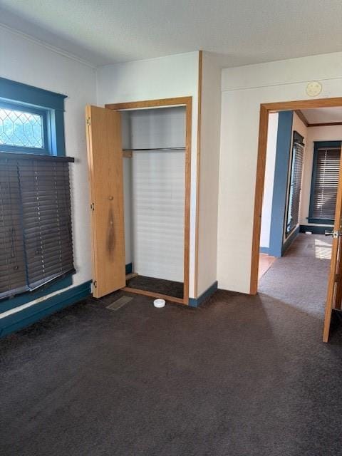 313 Shawnee St, Hiawatha, KS 66434 - unfurnished bedroom featuring carpet floors, baseboards, and a closet